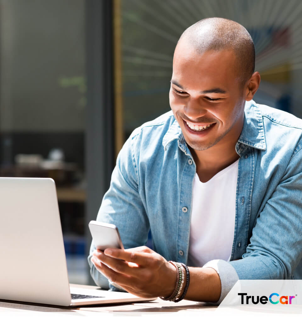 man smiles with TrueCar logo in bottom right corner