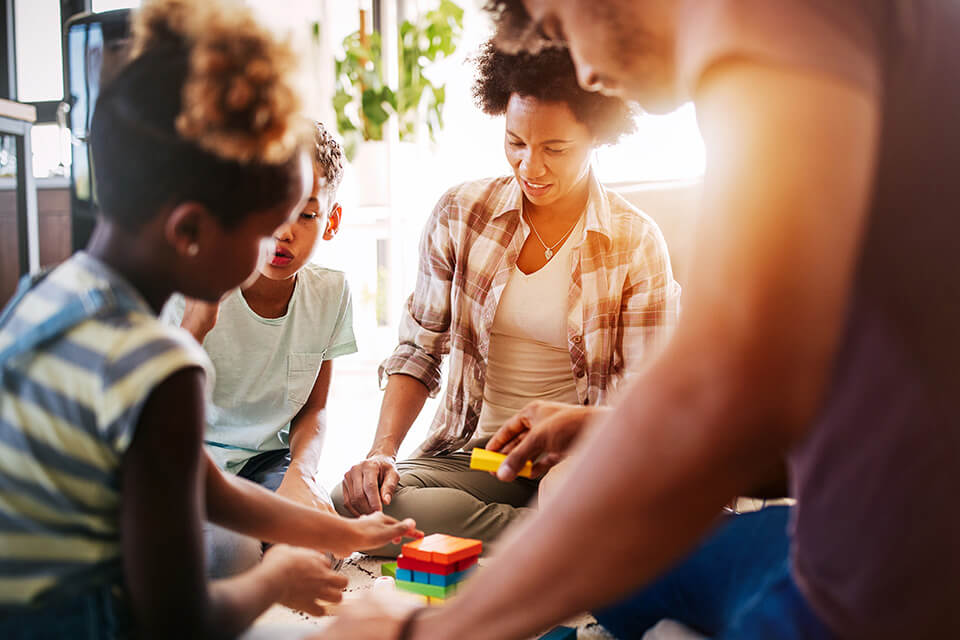 A family plays a game with different colored blocks