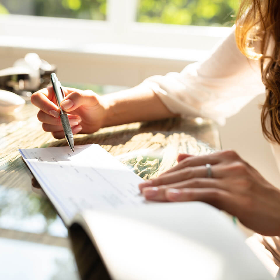 a woman is about to write a check