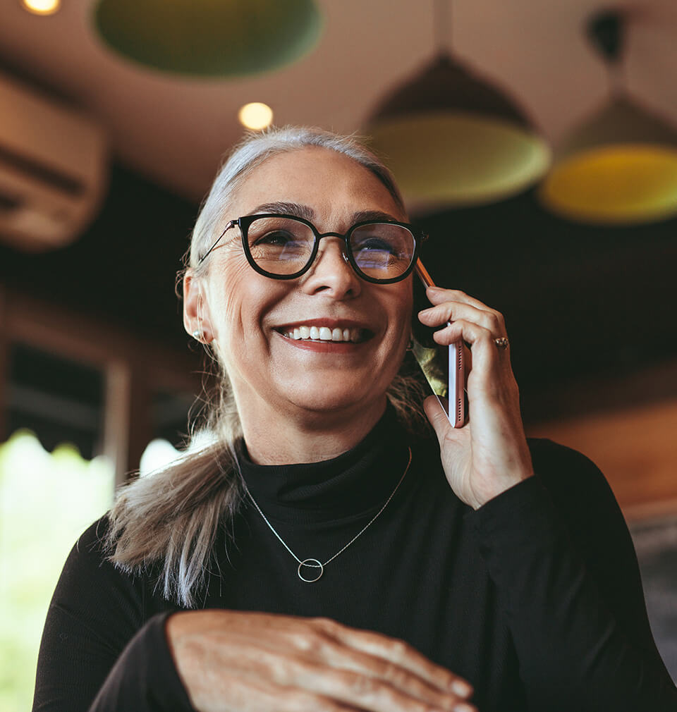 an older woman on the phone smiling