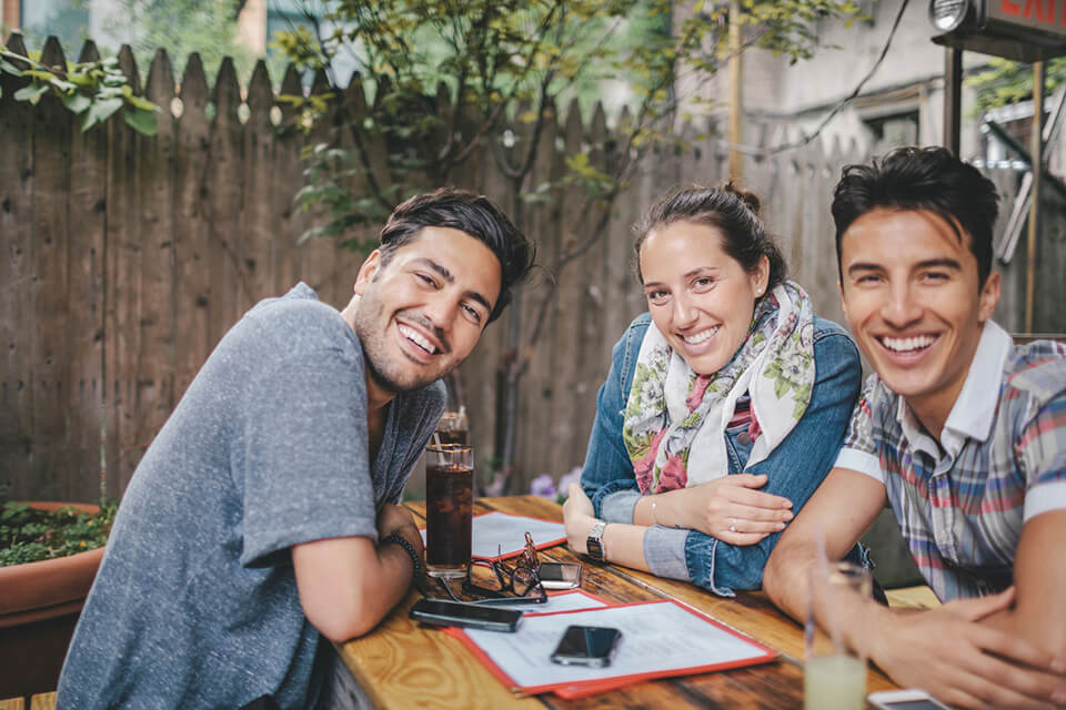 three friends smile at the camera, knowing their whole lives are ahead of them