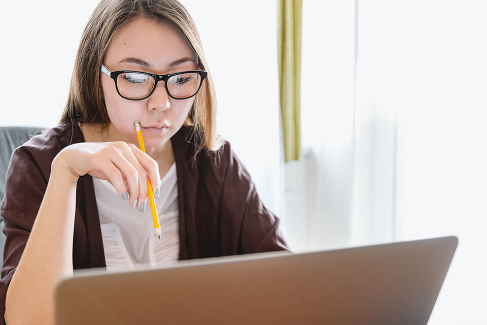 a girl studies something on her laptop