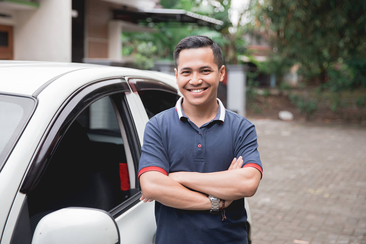 man in front of white car