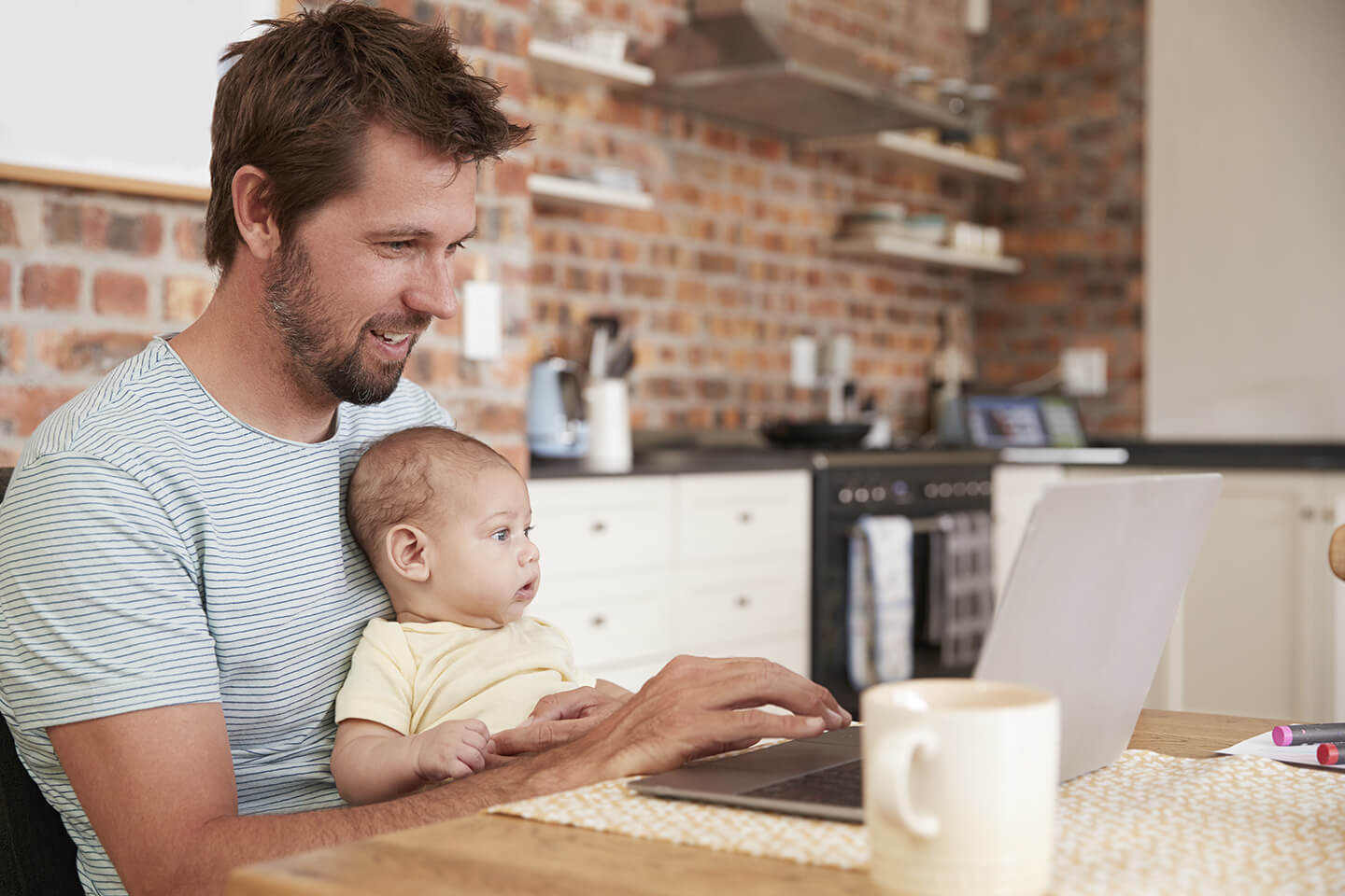 father and baby at a laptop computer