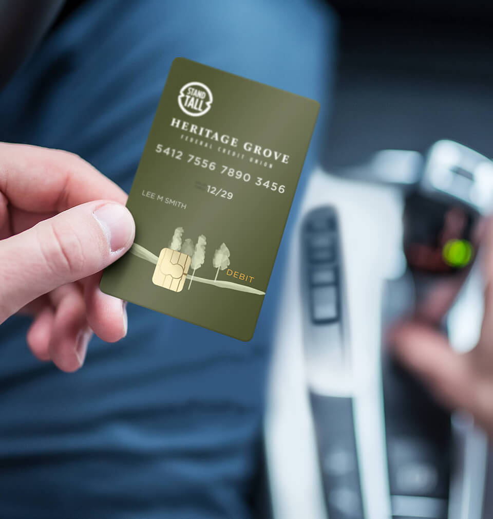 finger holding Heritage Grove VISA Debit Card