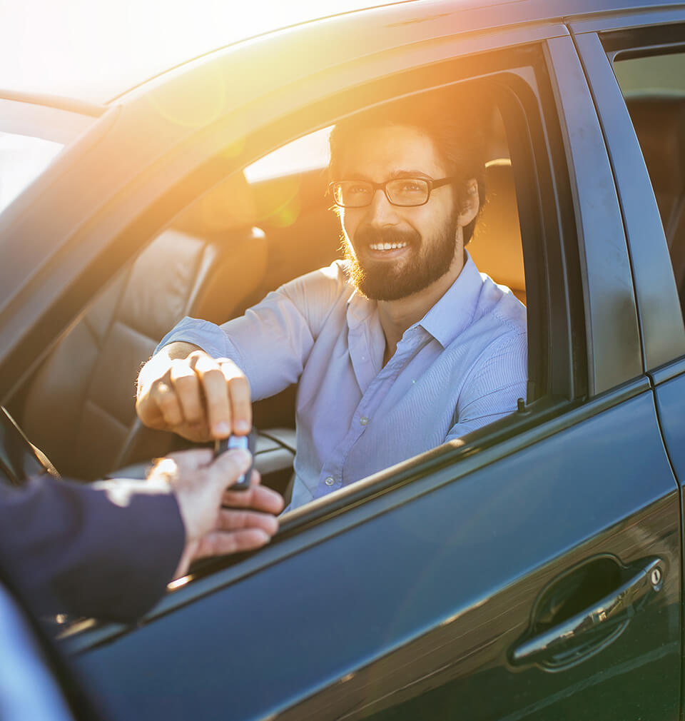 man in a car smiling